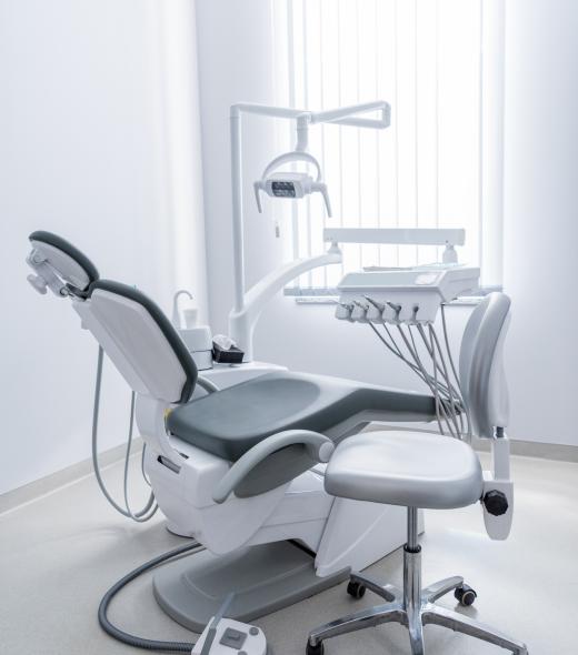 empty dentist office with chair and various dental equipment empty dentist office with chair and various dental equipment